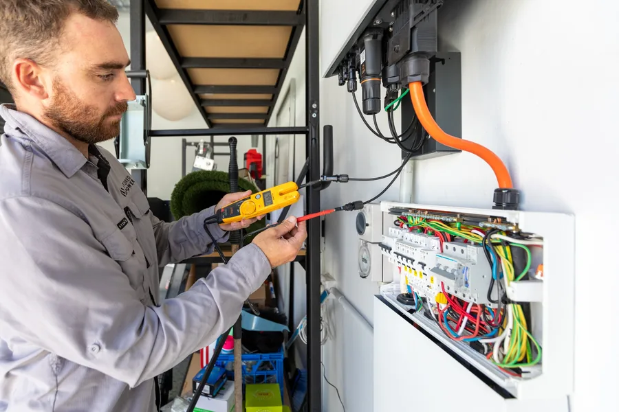 Stored Power electrician testing a solar battery and switchboard installation